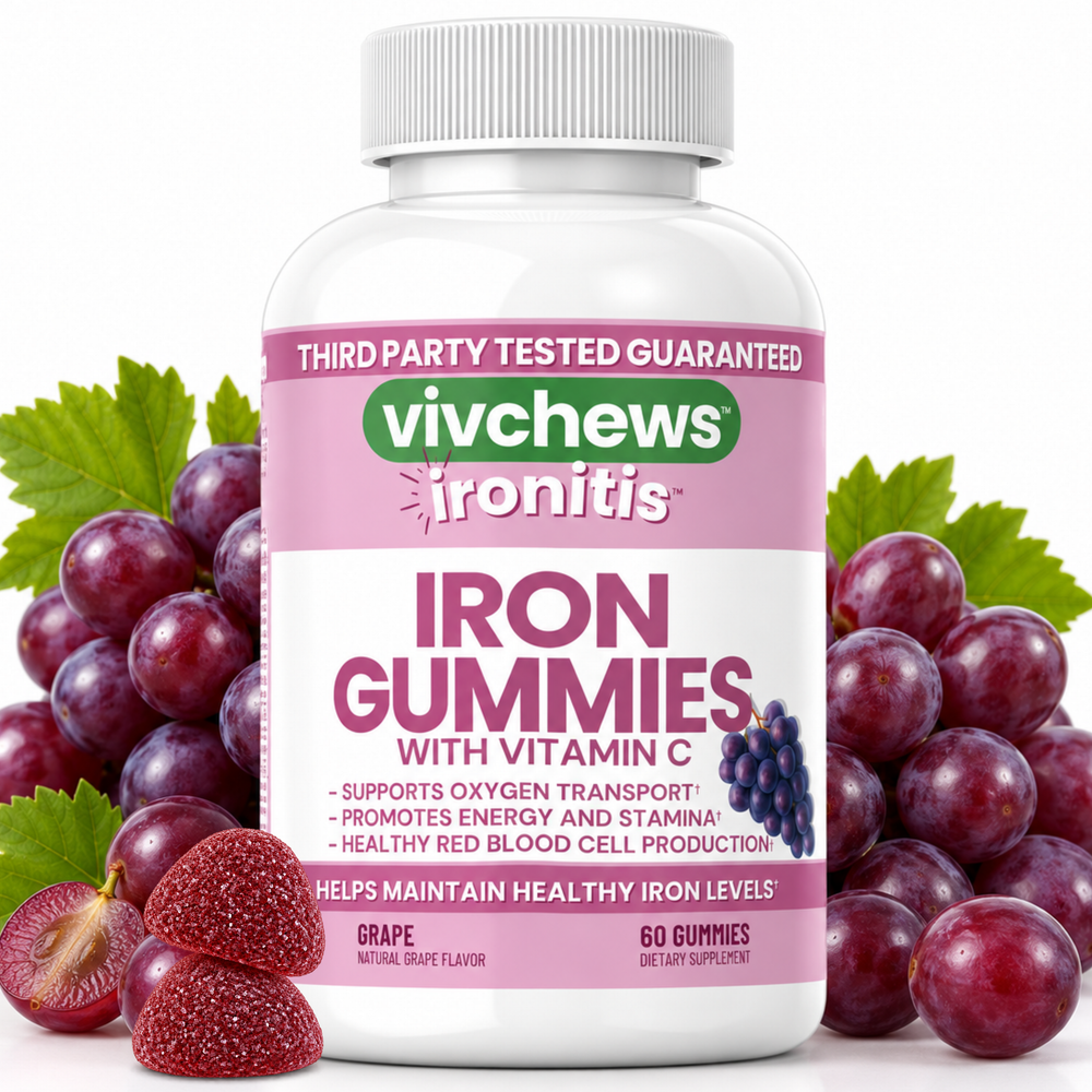 A bottle of vivchews Ironitis Grape gummies with Vitamin C, flanked by fresh grape leaves, whole grapes, and sliced strawberries on a white background.