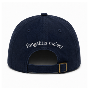 A navy blue cotton twill baseball cap shown from the back, featuring 'fungalitis society' embroidered in white script across the back panels and an adjustable strap with a brass-tone metal buckle.