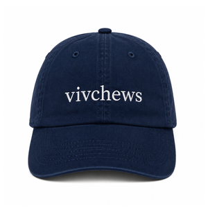 A navy blue cotton baseball cap with the word 'vivchews' embroidered in white lowercase serif letters across the front, shown against a plain white background.