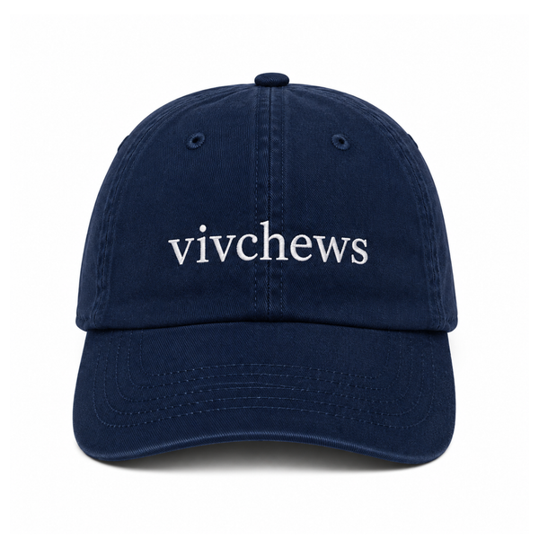 A navy blue cotton baseball cap with the word 'vivchews' embroidered in white lowercase serif letters across the front, shown against a plain white background.